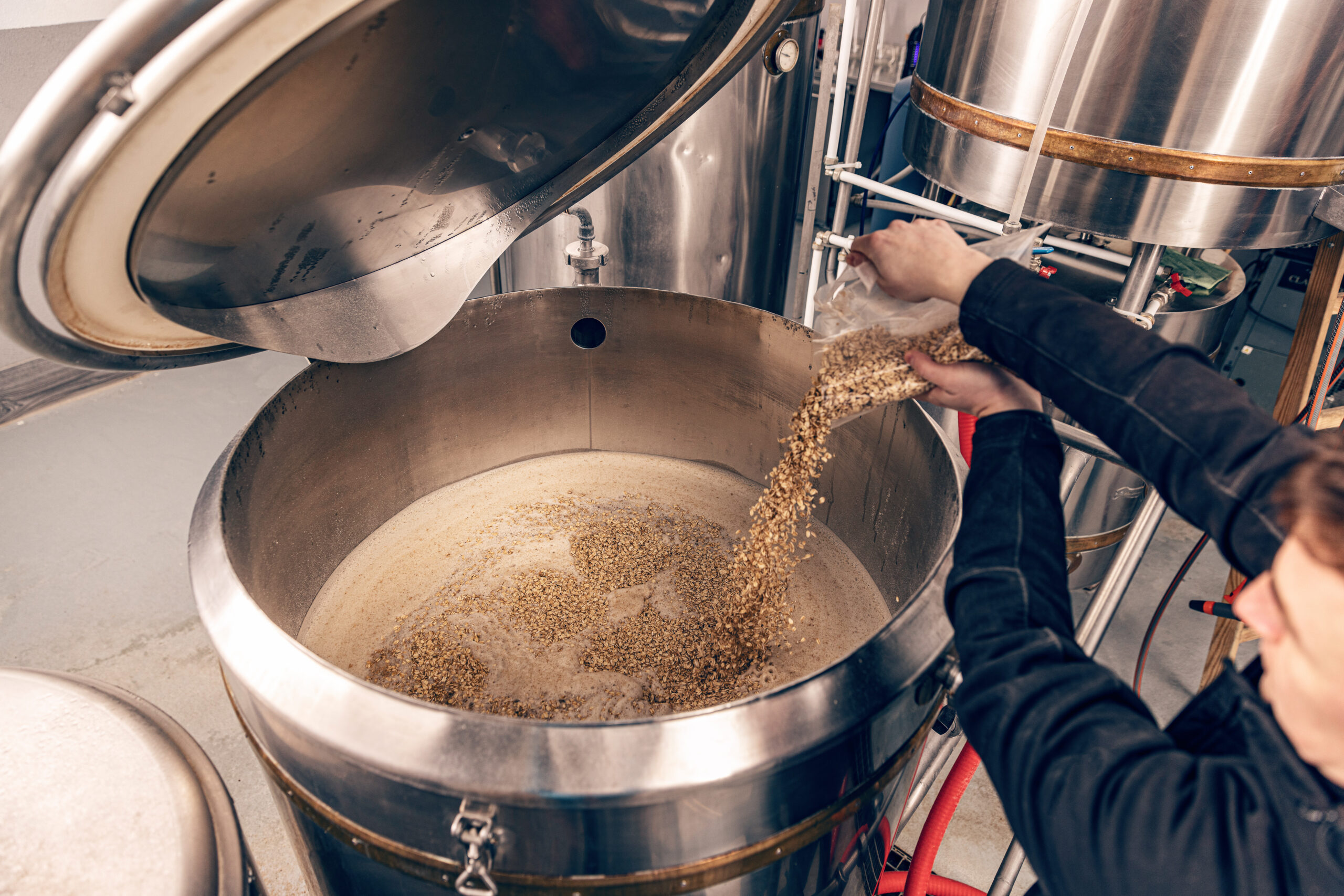 Industries 5 Clayton Industries – Advanced Steam Boiler Technology worker pours ingredients 2023 11 27 05 25 20 utc scaled Clayton Industries – Advanced Steam Boiler Technology