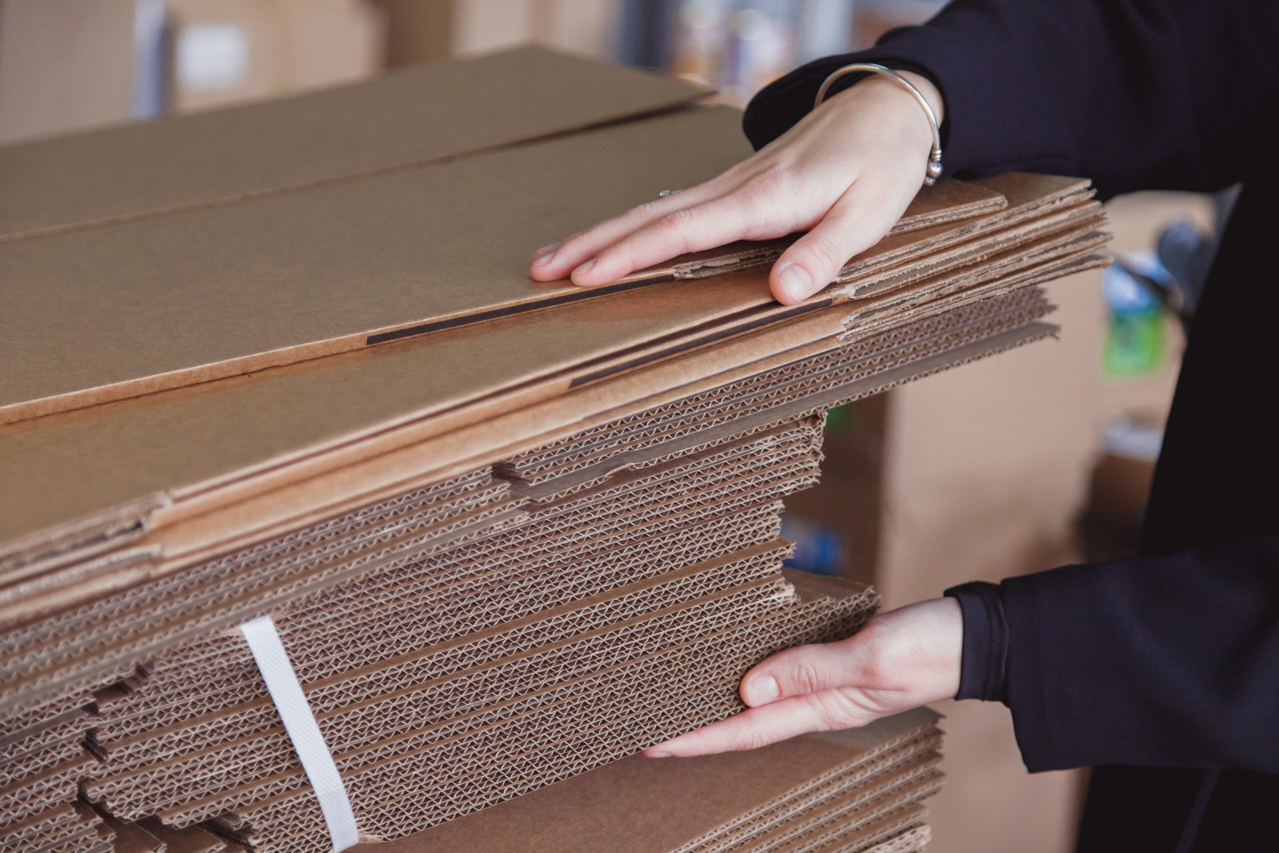 Industries 39 Clayton Industries – Advanced Steam Boiler Technology woman taking folded stacks of corrugated cardboard 2023 11 27 05 13 14 utc scaled Clayton Industries – Advanced Steam Boiler Technology